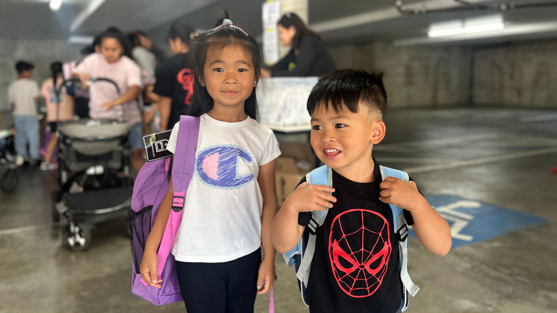 Kids with their new backpacks at 4Cs giveaway event
